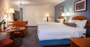 double queen bed hotel room with dining table