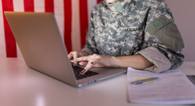 woman in military clothing on her computer