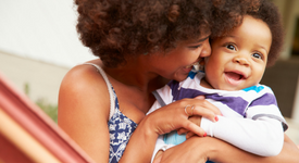 woman cuddling her baby