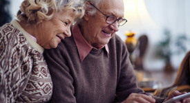 older couple looking at their smartphone