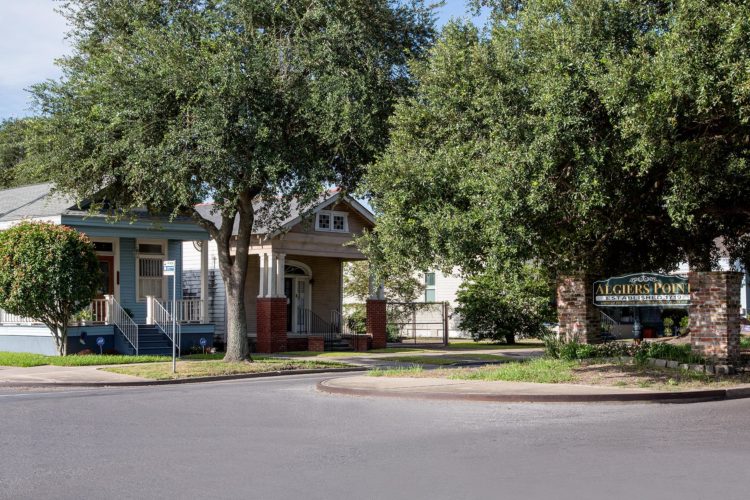 algiers point entrance sign next to two houses