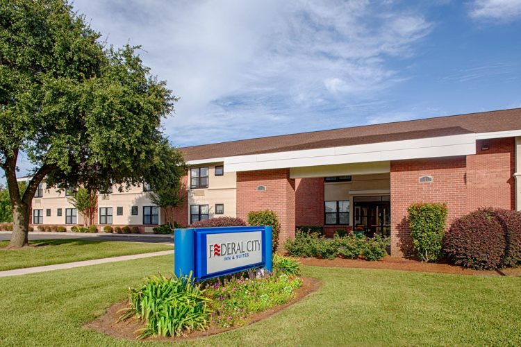 front entrance and sign to federal city inn and suites